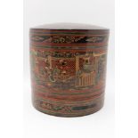 A 20th century Burmese lacquered food container, cylindrical box containing two inner bowls, red,