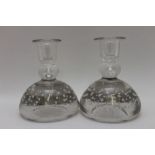 A pair of glass candlesticks, heavy bubble included bases, with flared rim nozzles, ground pontil