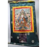 A 20th century Thangka, a Tibetan Buddhist unframed painting of the Buddha, mounted on a silk