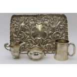 Comyns of London Ltd., A late Victorian embossed silver dressing table tray, birds and mask