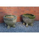 A pair of reconstituted stone planters, circular drum form, cast with fruiting vine decoration,