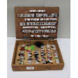 A softwood box containing a good selection of fishing flies