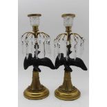 Two Regency design 19th century candlesticks, black painted eagle stems, on gilt brass bases, fitted