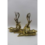 A pair of Eastern cast brass stylised reclining stags, with decorative coats & collars, 30.5cm high
