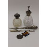 A sterling silver mounted cut glass scent atomiser, a silver mounted cut glass grenade form scent,