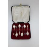 Henry Clifford Davis A set of six Art Deco silver coffee spoons, each with a harlequin of