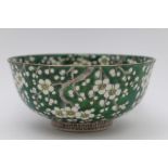 An Oriental ceramic bowl, blossom decoration on green ground, seal mark to base, 18.5cm in diameter