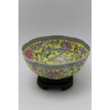 A Chinese eggshell porcelain bowl, of lobed form, hand painted famille decoration on a yellow