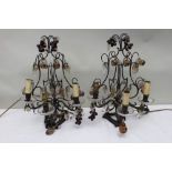 A pair of early 20th century French bronze table lights, lyre design forms with glass droppers, in