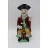 A 19th century Ralph Wood type Staffordshire pottery Toby jug, modelled as a figure wearing