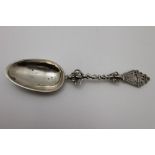 A 19th century Danish white metal commemorative spoon, decoratively cast handle & terminal with a