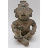 A reproduction Mexican seated terracotta figure of Mayan form, inscribed 'Mexico' to base, bearing