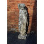 A reconstituted stone statue, classically draped young woman cradling a conch shell, 129cm high