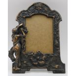 A cast iron frame of Art Nouveau form, coppered finish, Bacchus mask crest, a classically draped
