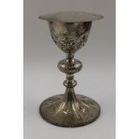 A 19th century European white metal chalice, embossed and chased decoration, the stem with large and