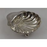 James Aitchinson, An Edwardian silver scallop shape bon-bon bowl, raised on three ball feet,