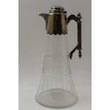 An Edwardian claret jug, silver plated collar and handle mount, with hinged cover, upon a