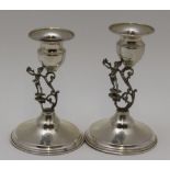 Two silver candlesticks, cast figural stems in the Art Nouveau style, raised on circular platform