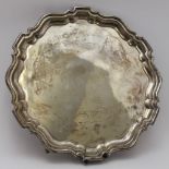 William Suckling Ltd. A silver salver of Georgian design, with piecrust rim, raised on three