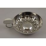 A French white metal taste vin, embossed decoration, ring handle with