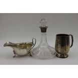 A cut glass liquor decanter of ships form, fitted silver collar, Birmingham 1990, and glass stopper,