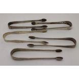 A collection of five pairs of George III silver sugar tongs, three pairs have bright cut decoration,