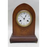 A Continental wooden cased mantel clock on stepped plinth base with spherical metal feet, 33cm high,