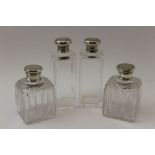 A pair of early 20th century silver topped plain glass scent bottles, London 1917, 12.5cm high,