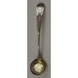 A George III silver sifting ladle, floral chased decoration, internally gilded bowl, monogrammed,