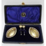 William Davenport, A cased pair of embossed silver salts, gilded interiors of elliptical form,