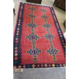 A traditional Kurdish flat weave Kilim, with two rows of central geometric forms within a