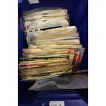 A box containing a selection of 7 inch records various