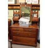 A late 19th/early 20th century mahogany coloured dressing chest with central adjustable