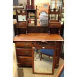 A late 19th/early 20th century mahogany coloured dressing chest with central adjustable