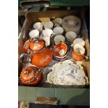 A box containing two ceramic part coffee services and a French faience butter dish and cover