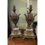 A pair of cast metal and onyx table lamps