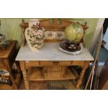A late 19th and early 20th century pine carcassed washstand, having fancy tiled splash back over