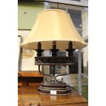 A decorative bronze effect table lamp and shade