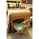 A mid century beechwood child's desk with tabre front, together with a box topped swivel chair