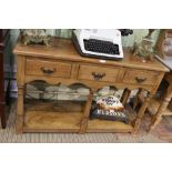 An early 20th century pine dresser base, with rectangular top over three inline drawers supported on