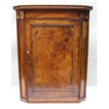 An early 19th century solid elm fronted hanging corner cupboard, 92.5cm high