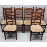 A set of six 20th century ladderback single chairs with turned spherical finials with rush seats 105