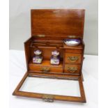 An Edwardian oak glass fronted writing cabinet