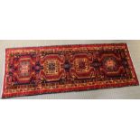 An Azabaijin woven long rug, four central motifs within a multi-guard border 2.9m x 1.1m