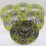 A set of six Chelsea style porcelain plates, yellow rim hand painted with vignettes of fancy birds,