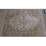 A Persian Kashan woven woollen carpet, floral design field on pale ground, 3.5m x 2.45m