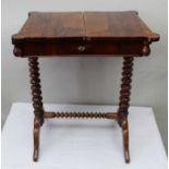 A 19th-century rosewood finished storage table, the plain top sliding out to reveal stotorage recess