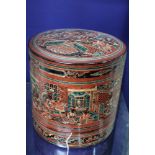 A 20th century Burmese lacquered food container, cylindrical box containing two inner bowls, red, bl