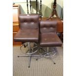 A pair of mid century gas lift charis finished in chocolate brown vinyl