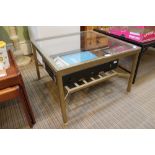 A glass top square form coffee table, on gold painted metal frame with lattice undertier